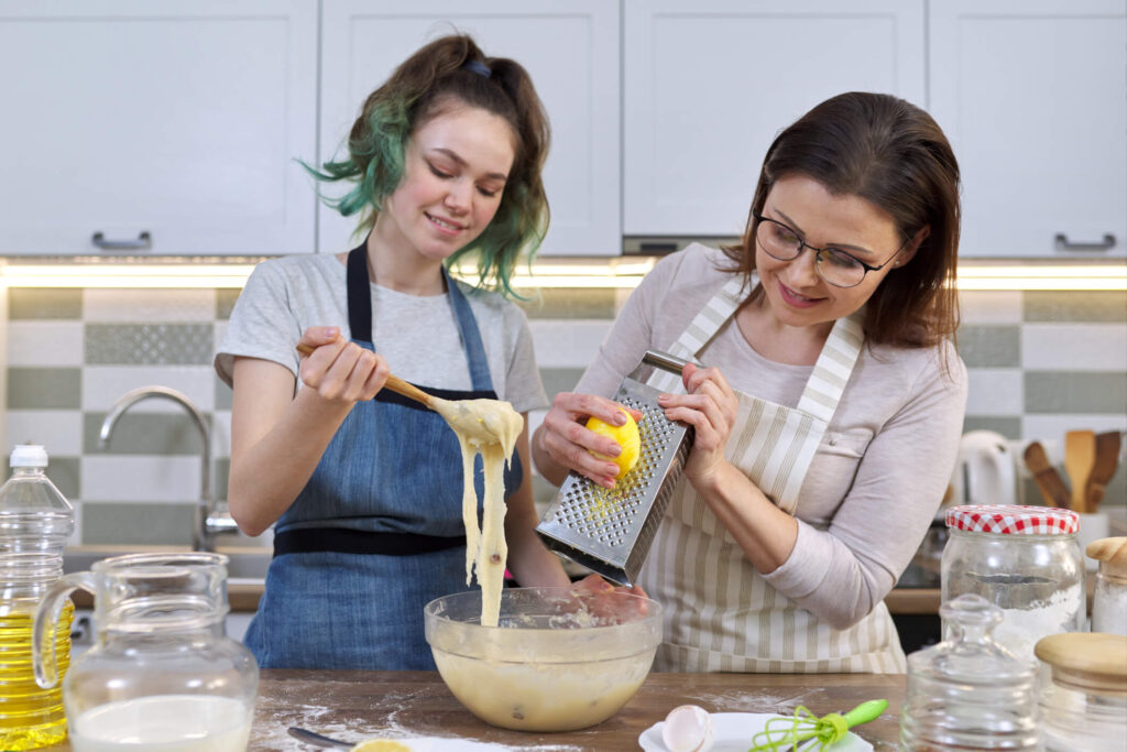 woman cooking with her teenage foster child